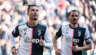 Juventus' Portuguese forward Cristiano Ronaldo (L) celebrates after scoring his second penalty, and his 50th goal with Juventus, during the Italian Serie A football match Juventus vs Fiorentina on February 2, 2020 at the Juventus Allianz stadium in Turin.