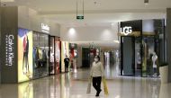 A cleaner worker wearing a mask walks at a shopping mall in Beijing's central business area, China, as the country is hit by an outbreak of the new coronavirus, February 2, 2020. Reuters/Jason Lee