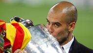 FILE PHOTO: Barcelona's manager Pep Guardiola kisses the trophy after their Champions League final soccer match victory against Manchester United at Wembley Stadium in London May 28, 2011. REUTERS/Phil Noble