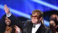 In this file photo taken on January 31, 2018 Elton John waves to fans on stage during the 