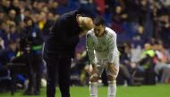 Real Madrid's French coach Zinedine Zidane (L) talks to Real Madrid's Belgian forward Eden Hazard during the Spanish league football match Levante UD against Real Madrid CF at the Ciutat de Valencia stadium in Valencia on February 22, 2020. / AFP / JOSE J