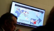  A map showing the distribution of coronavirus (COVID-2019) cases all around the world as of 22 February 2020 is displayed on a TV during a World Health Organization (WHO) news conference on the situation of the coronavirus (COVID-2019) in Geneva, Switzer