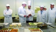French Economy and Finance Minister Bruno Le Maire (2ndL) chats with employees as he visits the French catering group Butard Enescot to talk about the consequences of the COVID-19 outspread on companies working for events in Colombes, near Paris on March 