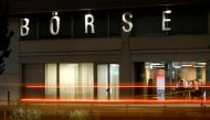 A long exposure shows traffic flowing past the illuminated word 