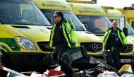 Staff prepare to load equipment into London Ambulance Service vehicles in the east car park at the ExCeL London exhibition centre in London on March 28, 2020. AFP / Glyn KIRK