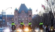 Mounted police officers ride down University Ave. through hospital row as Toronto first responders parade in front of the hospitals in Toronto, Ontario, Canada, in a salute to healthcare workers on April 19, 2020, amid the novel coronavirus pandemic. T/ A