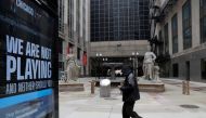 A man walks by a sign in front of the closed Chicago Board of Trade as the spread of the coronavirus disease (COVID-19) continues, in Chicago, Illinois, U.S., April 23, 2020. REUTERS/Shannon Stapleton