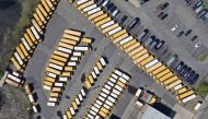 In this aerial image from a drone, unused school buses populate the First Student Bus Company parking lot on May 2, 2020 in Hicksville, New York. New York State Governor Andrew Cuomo announce yesterday that state schools will remain closed for this academ