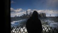 The Manhattan skyline stands in the distance as people ride the Staten Island Ferry, which commutes between Staten Island and Manhattan on May 09, 2020 in New York City. Spencer Platt/ AFP 
