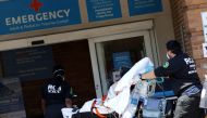 Paramedics wheel a patient into the emergency entrance outside Maimonides Medical Center in Brooklyn during the outbreak of the coronavirus disease (COVID-19) in New York City, New York, U.S., May 13, 2020. REUTERS/Mike Segar
