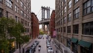 A handful of people stop on Washington Street in DUMBO neighborhood of Brooklyn with the Manhattan Bridge rising in the background as streets remain less busy due to the continuing outbreak of the coronavirus disease (COVID-19) in New York U.S., May 5, 20