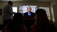 Torrey Pines High School graduating student Phoebe Seip, 18 (right), her father Jake, 57, and her sister Sydney, 22, watch former United States President Barack Obama deliver a virtual commencement address to millions of high school seniors who will miss 