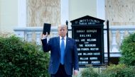 US President Donald Trump holds a Bible while visiting St. John's Church across from the White House after the area was cleared of people protesting the death of George Floyd June 1, 2020, in Washington, DC. AFP / Brendan Smialowski
