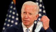 US Democratic presidential candidate and former Vice President Joe Biden takes off his face mask during a campaign event about the U.S. economy at Delaware State University in Dover, Delaware, U.S. June 5, 2020. REUTERS/Jim Bourg 
