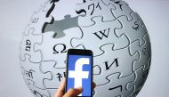  In this illustration photo, the logo of Facebook is displayed on a smartphone as Wikipedia logo at the background in Ankara, Turkey on June 16, 2020. ( Evrim Ayd?n - Anadolu Agency )