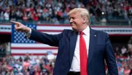 (FILES) In this file photo taken on February 10, 2020 US President Donald Trump gestures as he arrives to speak during a rally in Manchester, New Hampshire. / AFP / JIM WATSON