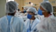 A COVID-19 patient is treated at the Oceanico hospital in Niteroi, Rio de Janeiro on June 22, 2020, during the coronavirus pandemic. Brazil is the second worst-affected country behind the United States, registering over 50,000 deaths. / AFP / CARL DE SOUZ