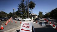 People in cars are lined up to be tested for COVID-19 as they make their way to a parking lot at Dodger Stadium amid the coronavirus pandemic on June 26, 2020 in Los Angeles, California. Mario Tama/Getty Images/AFP 