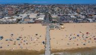 TOPSHOT - An aerial view shows people on the beach during a heatwave as coronavirus cases reach new record levels in states across the nation, in Hermosa Beach, California, on July 12, 2020. / AFP / DAVID MCNEW
