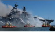 Boats combat a fire on board the U.S. Navy amphibious assault ship USS Bonhomme Richard at Naval Base San Diego, California, U.S. July 12, 2020. Picture taken July 12, 2020. U.S. Navy/Mass Communication Specialist 3rd Class Christina Ross/Handout via REUT
