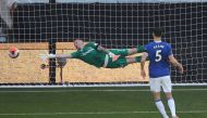 Wolverhampton Wanderers' Belgian midfielder Leander Dendoncker (not in picture) scores past Everton's English goalkeeper Jordan Pickford during the English Premier League football match on July 12, 2020. AFP / POOL / MOLLY DARLINGTON