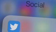 In this file photo taken on July 10, 2019, the Twitter logo is seen on a phone in this photo illustration in Washington, DC. The official Twitter accounts of Apple, Elon Musk, Jeff Bezos and others were hijacked on Wednesday by scammers trying to dupe peo