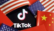 China and U.S. flags are seen near a TIKTOK logo in this illustration picture taken July 16, 2020. REUTERS/Florence Lo/Illustration
