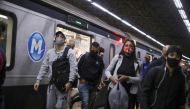 Commuters walk as they arrive at a metro station, amid the coronavirus disease (COVID-19) outbreak, in Rio de Janeiro, Brazil July 15, 2020. Picture taken July 15. REUTERS/Pilar Olivares
