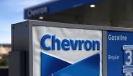 In this file photo a sign is posted in front of a Chevron gas station on February 2, 2018 in Corte Madera, California. Chevron said July 20, 2020 it had agreed to buy US exploration and production company Noble Energy for $5 billion, the biggest petroleum