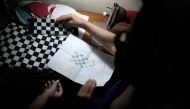 Sofia Valenzuela shows a tailor a drawing of a mask she would like to wear during a photo session for her quinceanera (coming of age of 15-year-olds) celebration amid coronavirus disease (COVID-19) spread concerns, in Havana, Cuba, July 14, 2020. Picture 