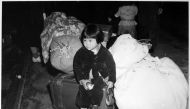 This photo obtained July 21, 2020 courtesy of the US National Archives shows two-year-old Yuki Okinaga Hayakawa, an evacuee of Japanese ancestry waiting with the family baggage before leaving by bus for an assembly center in the spring of 1942, taken by W