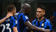 Inter Milan's Argentinian forward Lautaro Martinez (R) celebrates with Inter Milan's Belgian forward Romelu Lukaku (C) after scoring during the Italian Serie A football match Inter Milan vs Napoli played behind closed doors at the San Siro Stadium in Mila