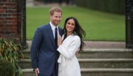 (FILES) In this file photo taken on November 27, 2017 Britain's Prince Harry and his fiancée US actress Meghan Markle pose for a photograph in the Sunken Garden at Kensington Palace in west London, following the announcement of their engagement./ AFP / Da