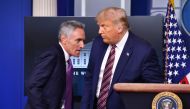 US President Donald Trump introduces Senior Fellow at Stanford University's Hoover Institution, Dr. Scott Atlas, during a news conference in the Brady Briefing Room of the White House in Washington, DC, on August 12, 2020. / AFP / Nicholas Kamm
