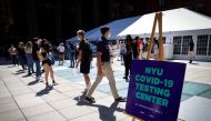 People wear protective masks as they wait in line at a testing site for the coronavirus disease (COVID-19) set up for returning students, faculty and staff on the main campus of New York University (NYU) in Manhattan in New York City, New York, U.S., Augu