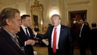 (FILES) In this file photo former Trump advisor Steve Bannon (L) watches as US President Donald Trump greets Elon Musk, SpaceX and Tesla CEO, before a policy and strategy forum with executives in the State Dining Room of the White House February 3, 2017 i