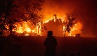 TOPSHOT - A home burns in Vacaville, California during the LNU Lightning Complex fire on August 19, 2020. As of the late hours of August 18,2020 the Hennessey fire has merged with at least 7 fires and is now called the LNU Lightning Complex fires. Dozens 