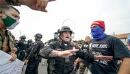 A Los Angeles police officer attempts to stop a confrontation between Trump supporters (R) and counter-protestors during a pro-Trump rally in Tujunga, 25 miles north of Los Angeles (40km), California, August 21, 2020. / AFP / Kyle Grillot
