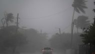 A pickup truck drives on a road as Tropical storm Laura hits Guayama, Puerto Rico on August 22, 2020. / AFP / Ricardo ARDUENGO
