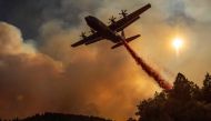 An aircraft drops fire retardant on a ridge during the Walbridge fire, part of the larger LNU Lightning Complex fire as flames continue to spread in Healdsburg, California on August 20, 2020./ AFP / JOSH EDELSON