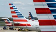 A member of a ground crew walks past American Airlines planes parked at the gate during the coronavirus disease (COVID-19) outbreak at Ronald Reagan National Airport in Washington, U.S., April 5, 2020. REUTERS/Joshua Roberts