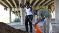 Cobie Brown and Ken Allen (L-R) fill sandbags as they prepare for the arrival of Tropical Storm Marco and possibly Hurricane Laura on August 24, 2020 in Morgan City , Louisiana. The Gulf Coast is expecting to see some impact from Tropical Storm Marco foll