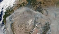 This NASA Earth Observatory image released on August 25, 2020 shows on August 21, 2020, what the Moderate Resolution Imaging Spectroradiometer on NASA’s Terra satellite captured in natural-color imagery of smoke plumes from wildfires in California and oth