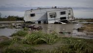 HOLLY BEACH, LA - AUGUST 27: A damaged travel trailer sits among flood water after Hurricane Laura passed through the area August 27, 2020 in Holly Beach, Louisiana. Hurricane Laura came ashore bringing rain and high winds to the South East region of the 