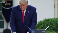 (FILES) In this file photo taken on March 30, 2020, US President Donald Trump holds a 5-minute test for Covid-19 from Abbott Laboratories during the daily briefing on the coronavirus pandemic, in the Rose Garden of the White House in Washington, DC. Trump