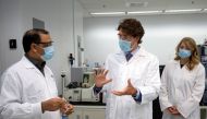 Canada's Prime Minister Justin Trudeau accompanied by Melanie Joly (R) Canada's Minister of Economic Development and Official Languages speaks with Krishnaraj Tiwari about vaccines at the National Research Council of Canada in Montreal, Quebec, Canada Aug