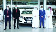 Representatives of Qatar Cancer Society and Saleh Al Hamad Al Mana Co during handover of the vehicle. 