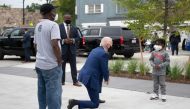 Democratic Presidential Candidate Joe Biden speaks CJ Brown (R), the owner's son, as he shops for his grandkids at the Three Thirteen store in Detroit, Michigan, on September 9, 2020. AFP / Jim Watson 