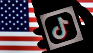 (FILES) In this file photo illustration, the social media application logo, TikTok is displayed on the screen of an iPhone on an American flag background on August 3, 2020 in Arlington, Virginia. / AFP / Olivier DOULIERY
