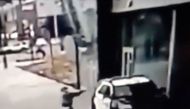 A man aims at a police vehicle in Compton, California, U.S., September 12, 2020 in this still image taken from a video tweeted by the LASD. LOS ANGELES COUNTY SHERIFF'S DEPARTMENT / via REUTERS